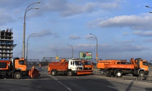 Trucks, normally used as snow ploughs to clear the city’s streets, are stationed as a check point to slow vehicles down, along a main road leading into Kyiv.