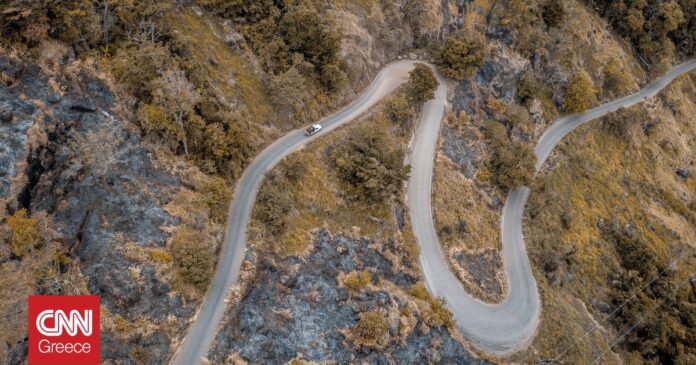 bf132e18-aerial-shot-curvy-road-mountains-with-trees-og.jpg